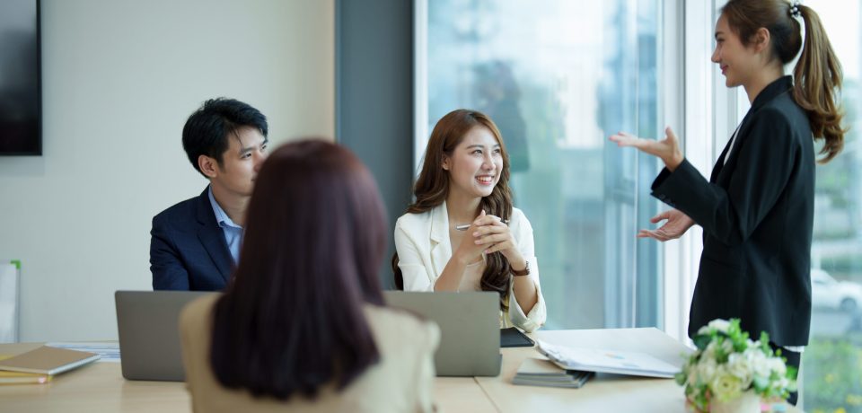 Group of asian business meeting and discussing with new startup idea project. Creative business people planning strategy analysis and brainstorm with document report in office.