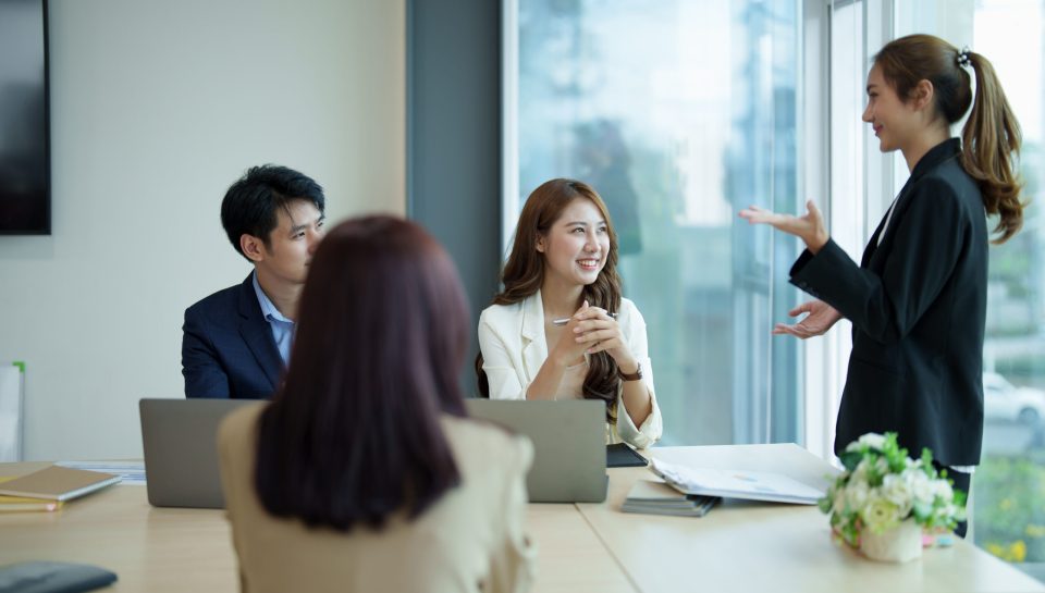 Group of asian business meeting and discussing with new startup idea project. Creative business people planning strategy analysis and brainstorm with document report in office.