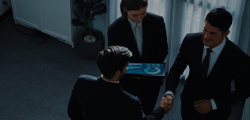 Top down aerial view of smart manager standing with diverse team and analyze financial data from tablet. Female leader joining the group making a deal and sharing marketing strategy. Directorate.