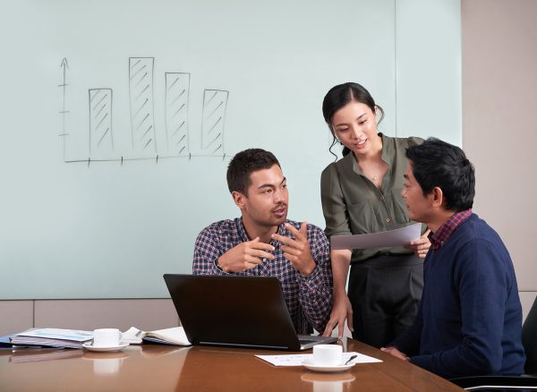 Group of young coworkers discussing project together