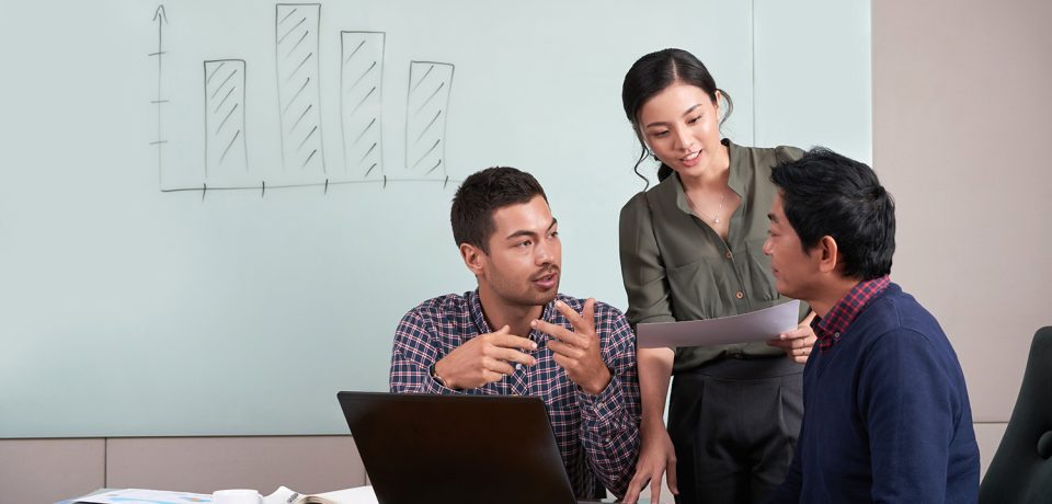 Group of young coworkers discussing project together