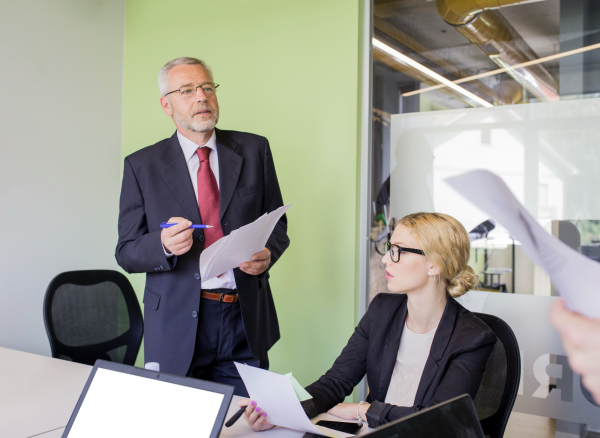 CEO and CFO rehearsing investor presentation preparation with an adviser